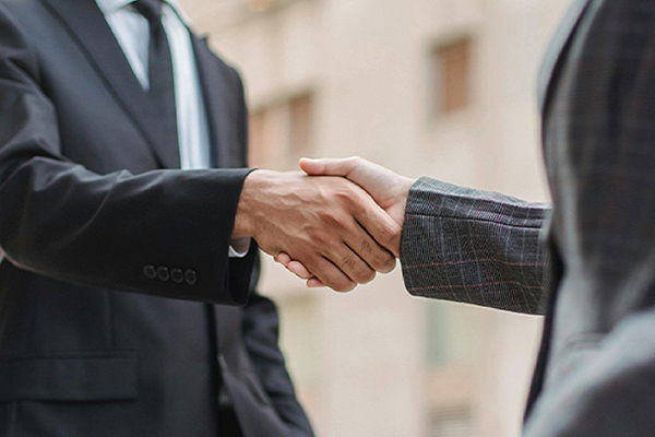Handshake of two people in suits.